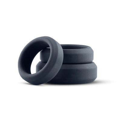 Set of three black soft silicone cock rings in varying sizes stacked on white background