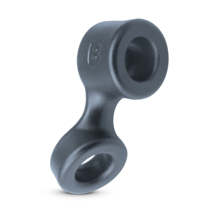 Black flexible silicone cock ring and ball stretcher combo with two connected circular openings.