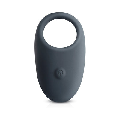 Sleek dark gray vibrating cock ring with a power button on the front, designed for comfort and enhanced pleasure.