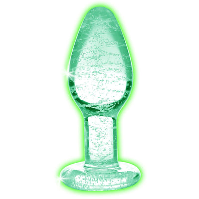 Small clear glass anal plug with bubbles inside glowing green in the dark, smooth tapered shape with flared base.
