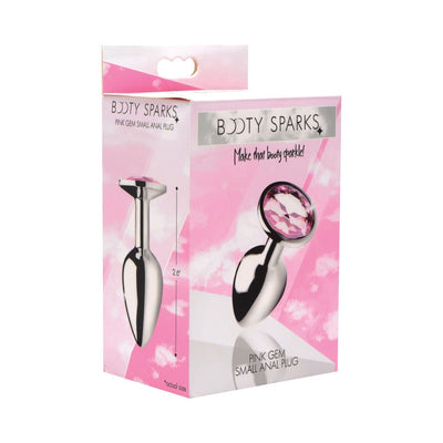 Packaging box of Booty Sparks small metal anal plug with a pink gem on the base, shown against a pink and white background.