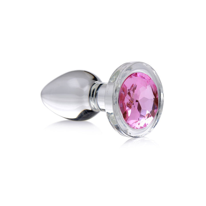 Small clear glass anal plug with a faceted pink gem base, smooth tapered design for beginner use.