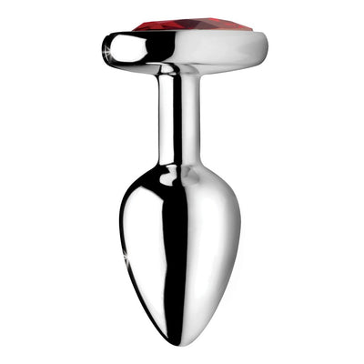 Small silver metal anal plug with a tapered shape and a red heart-shaped gem at the base.