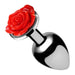 Small metal anal plug with a smooth silver finish and a decorative bright red rose at the base.