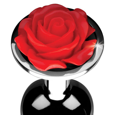 Small metal anal plug with a shiny black finish and a decorative red rose flower on the base.