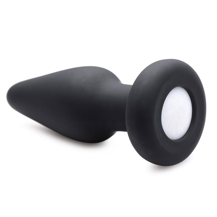 Small black silicone tapered anal plug with a round base featuring a white LED light insert.