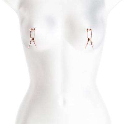 Rose gold adjustable nipple clamps with soft silicone tips displayed on a white mannequin torso.