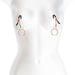 Rose gold adjustable nipple clamps with black silicone tips and attached rings displayed on a white mannequin torso.