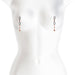 Rose gold adjustable nipple clamps with black silicone tips and dangling beads displayed on a white mannequin torso.