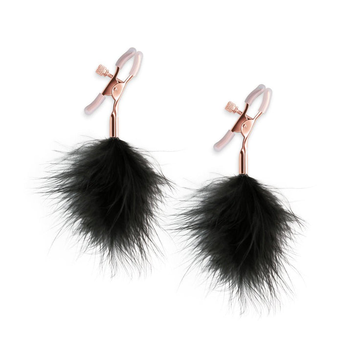 Rose gold adjustable nipple clamps with soft silicone tips and black feather accents for gentle sensory play.