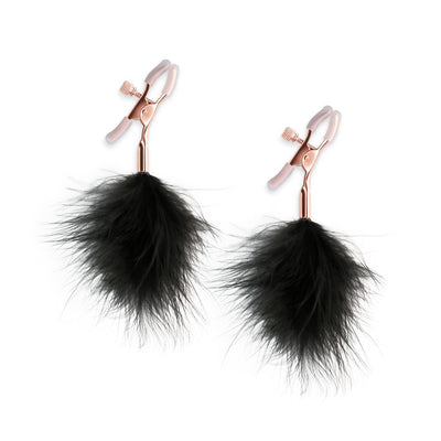 Rose gold adjustable nipple clamps with soft silicone tips and black feather accents for gentle sensory play.