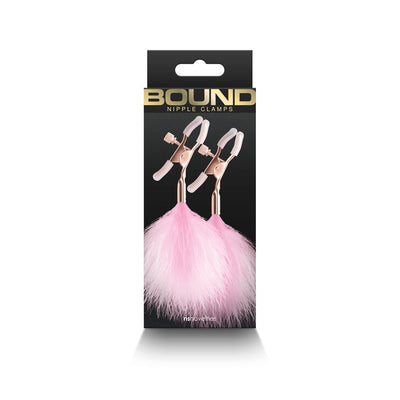 Bound F1 adjustable rose gold nipple clamps with soft pink silicone tips and fluffy pink feather accents in black packaging.