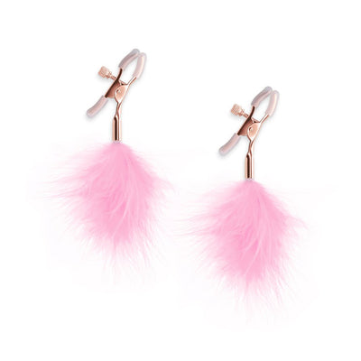 Rose gold adjustable nipple clamps with soft silicone tips and attached pink feather accents on a white background.