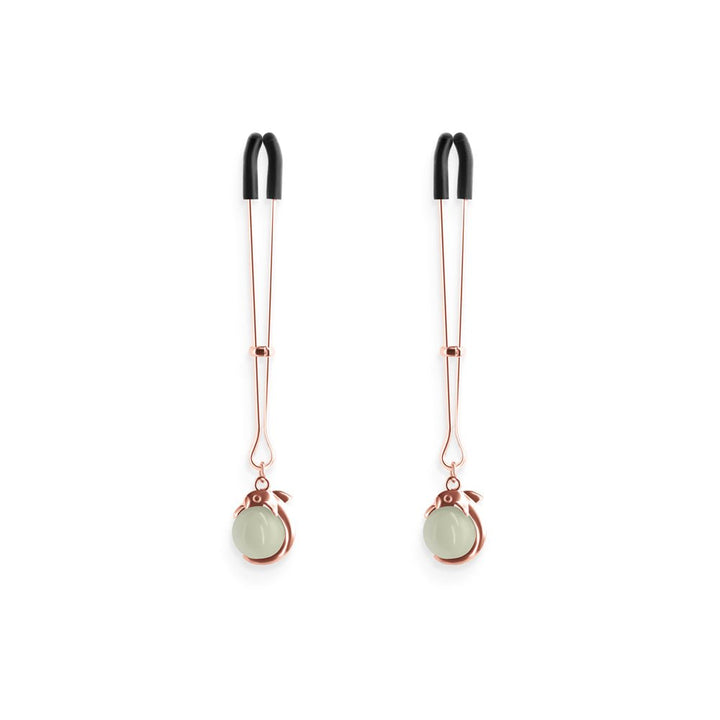Pair of rose gold adjustable nipple clamps with black silicone tips and decorative round accents.