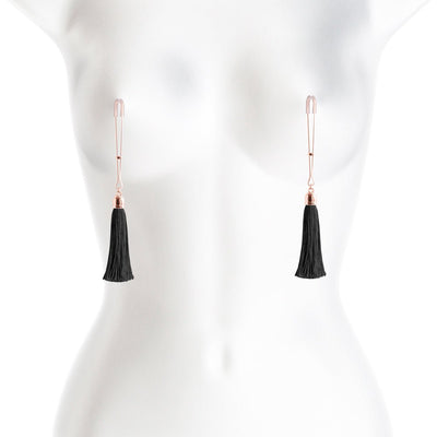 Rose gold adjustable nipple clamps with black tassels displayed on a white mannequin torso.