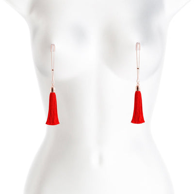 Rose gold adjustable nipple clamps with soft silicone tips and red tassel accents displayed on a white mannequin torso.