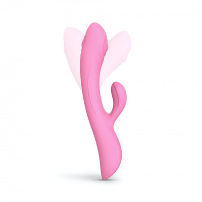 Pink dual stimulator with curved shaft and smaller external arm, shown with motion effect on white background.