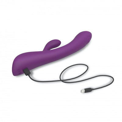 Purple dual stimulator with curved design and USB charging cable on white background.