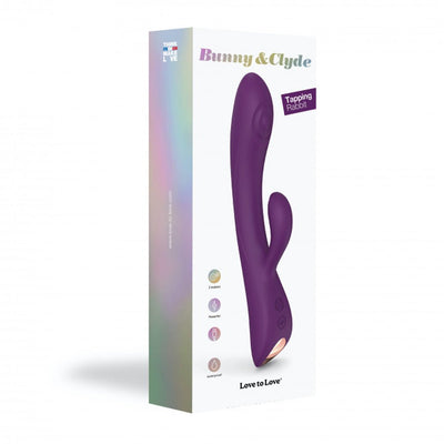 Purple Bunny & Clyde dual stimulator with ergonomic design shown on white packaging box with product features icons.