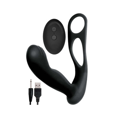 Black silicone prostate massager with scrotum ring, wireless remote control, and USB charging cable on white background.