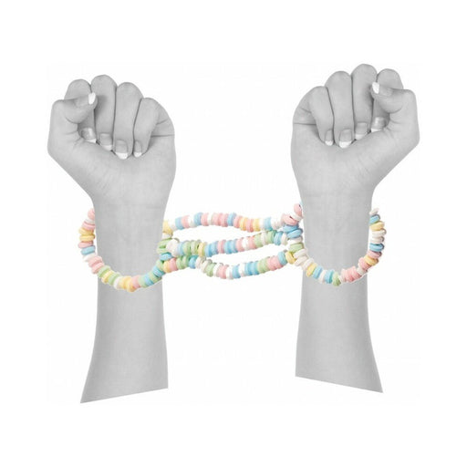 Hands linked by colorful candy bead cuffs, showcasing playful edible restraint accessory.