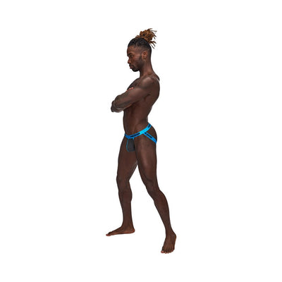 Male model wearing Casanova Uplift Jock in gray with blue waistband, standing in profile with arms crossed.