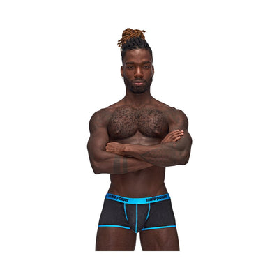 Muscular man wearing black and blue Casanova Uplift Mini Shorts with crossed arms on white background.