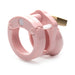 Compact pink male chastity cage with locking mechanism and vented design for comfort and hygiene.