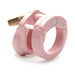Compact pink male chastity cage made of smooth, durable polycarbonate with a brass lock and adjustable ring.