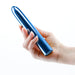 Hand holding a sleek, metallic blue 7-inch rechargeable vibrator with a smooth, rounded design.