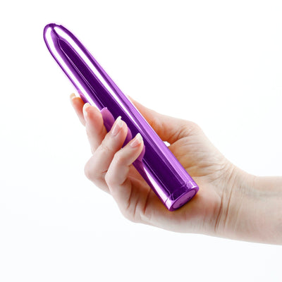 Hand holding a sleek, rechargeable purple 7-inch vibrator with a smooth, glossy finish.