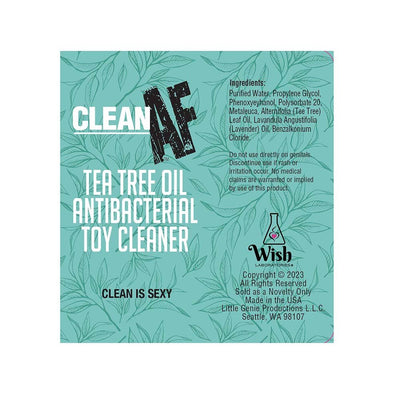 Clean AF Tea Tree Oil Antibacterial Toy Cleaner label with ingredients and usage information on a green leafy background.
