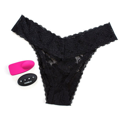 Black lace thong panty with pink wearable bullet vibrator and black wireless remote control on white background.