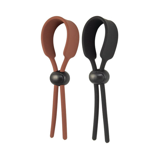 Set of two adjustable silicone cock loops in brown and black with sliding locking beads for customizable fit.