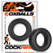 Black silicone cock ring with embossed logo, shown in and out of branded Oxballs packaging.