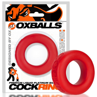 Red silicone cock ring with smooth texture, shown in and out of branded OXBALLS packaging.