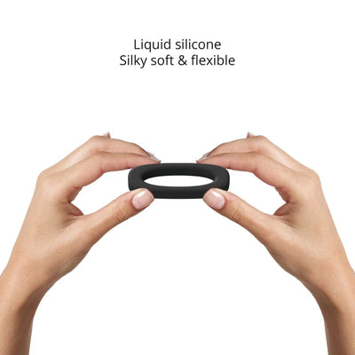 Hands holding a flexible black liquid silicone cockring, highlighting its soft and stretchy texture.