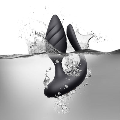 Black waterproof dual-motor couples toy with textured and smooth flexible silicone design submerged in water with bubbles.