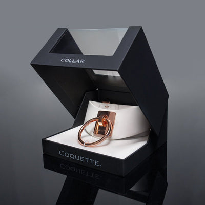White vegan leather choker with rose gold metal ring and engraved plate in black Coquette display box.