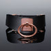 Black vegan leather collar with rose gold metal ring and engraved Coquette plate, adjustable buckle closure.