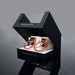 Coquette Pleasure Collection white vegan leather cuffs with rose gold metal rings in black display box labeled handcuffs.