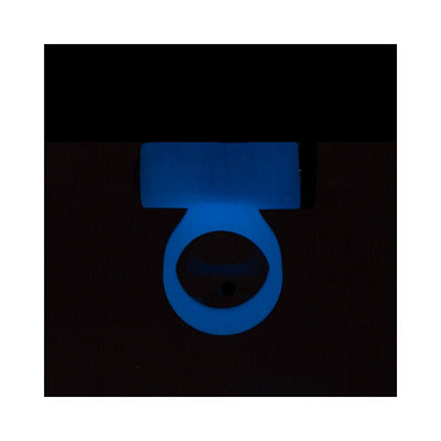 Glow-in-the-dark blue silicone cock ring with rechargeable bullet vibrator glowing in low light.