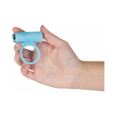 Hand holding a light blue silicone cock ring with a rechargeable bullet vibrator attached, featuring raised dots for stimulation.