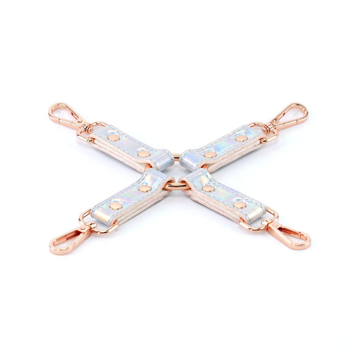 Holographic vinyl bondage hogtie with rose gold hardware and adjustable straps on white background.
