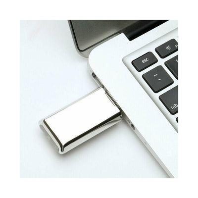 Crave Duet clitoral stimulator USB charger plugged into a laptop for discreet charging.