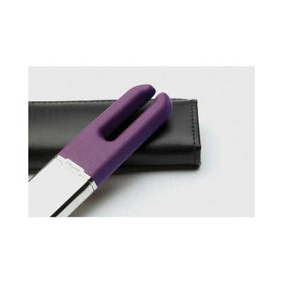 Purple dual-pronged Crave Duet clitoral stimulator with silver base resting on a black leather pouch.