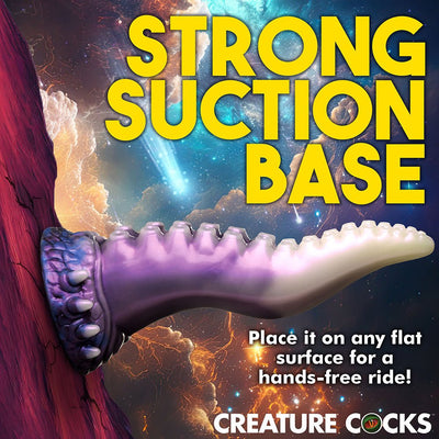 Purple and white tentacle-shaped silicone toy with suction cup base attached to a vertical surface against a cosmic background.