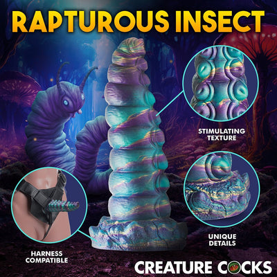 Iridescent teal, purple, and gold segmented fantasy caterpillar dildo with suction base and harness compatibility details.