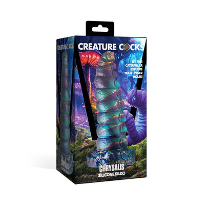 Packaging of Creature Cock Chrysalis silicone dildo with iridescent teal, purple, and gold caterpillar design in fantasy forest artwork.