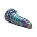 Iridescent teal, purple, and gold fantasy caterpillar-shaped silicone adult toy with textured segmented body and suction base.